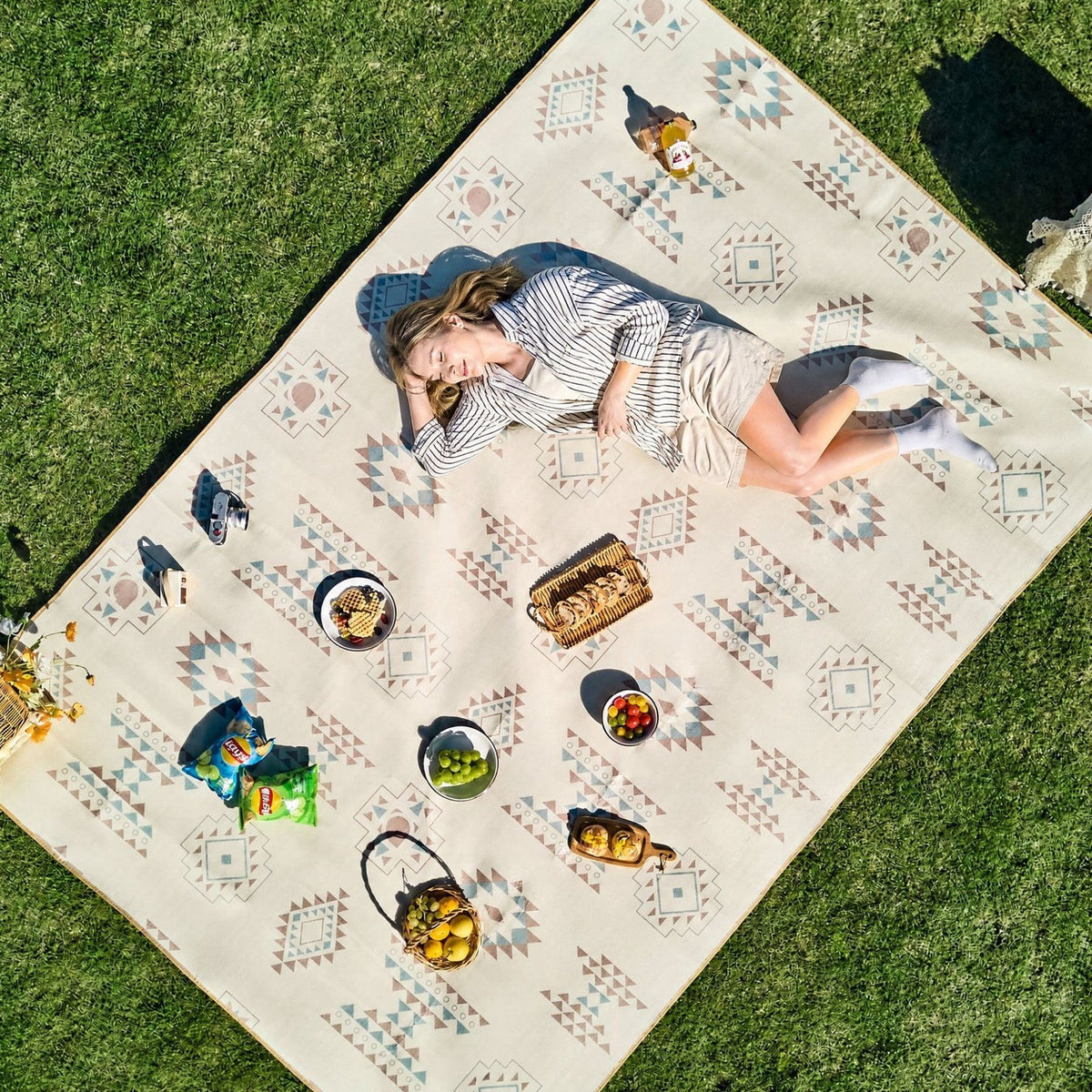 Flat lay of the printed picnic mat on grass