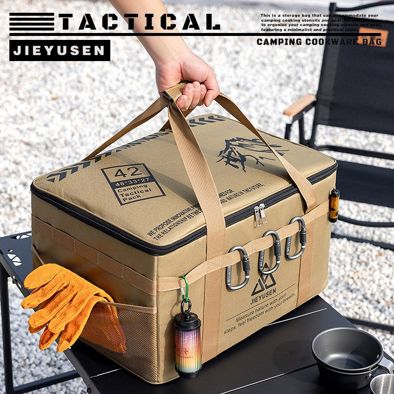 Camping storage bag being carried by its handles next to a cooking pot