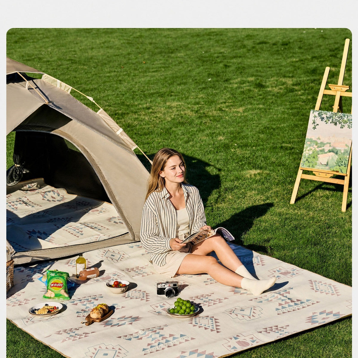 Aztec printed picnic mat laid out on an open field