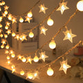 Warm white solar string lights with clear star and round bead covers on copper wire