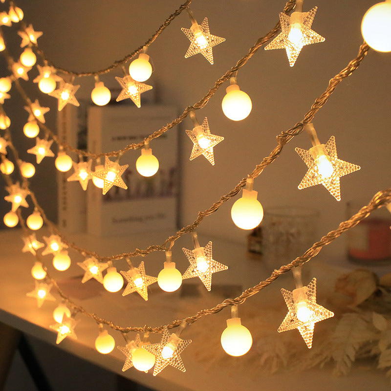 Warm white solar string lights with clear star and round bead covers on copper wire