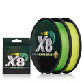 Two spools of green and yellow 8-strand PE braid line next to the retail box